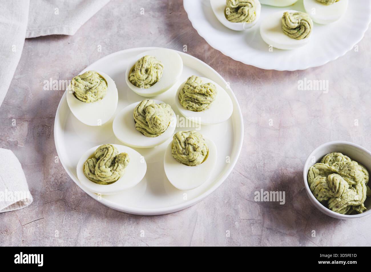 Avocado deviled eggs for appetizer on plate on table Stock Photo