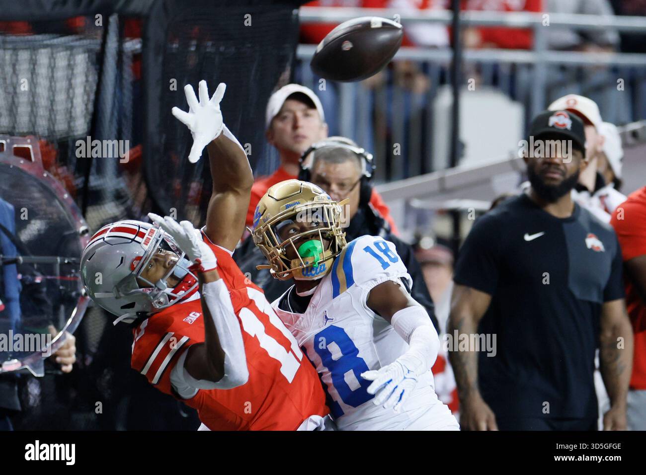 UCLA defensive back Rodrick Pleasant, right, interferes with Ohio State ...
