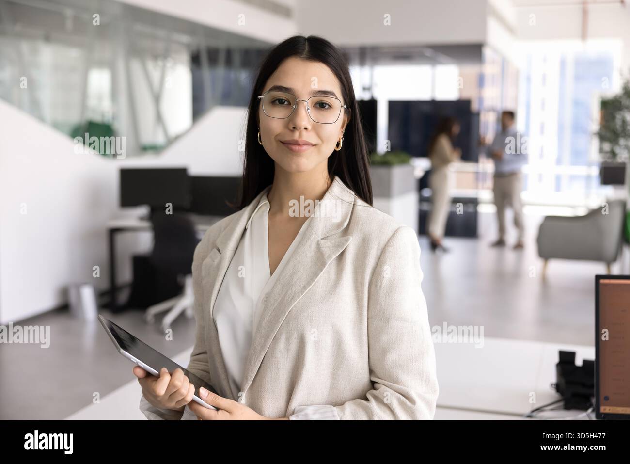 Confident beautiful young Asian business professional looking at camera Stock Photo