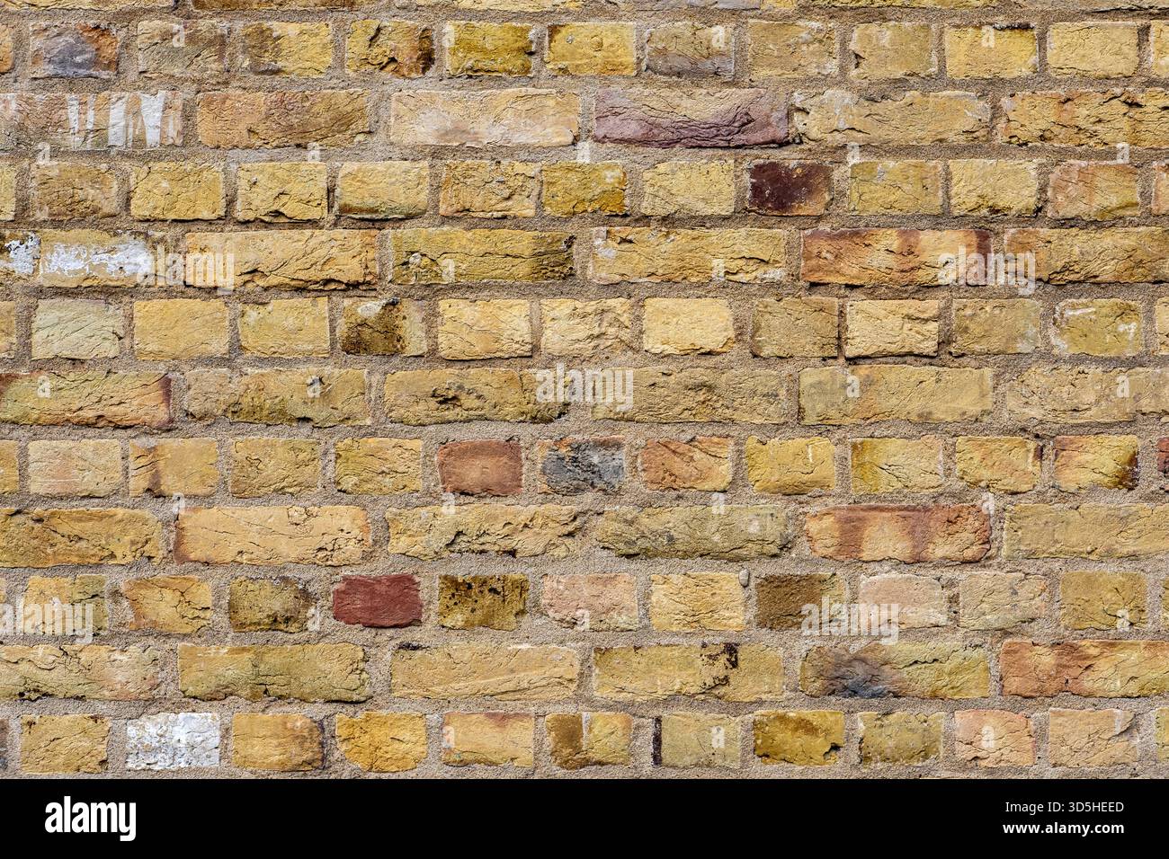 Background from a wall made of old beige bricks Stock Photo