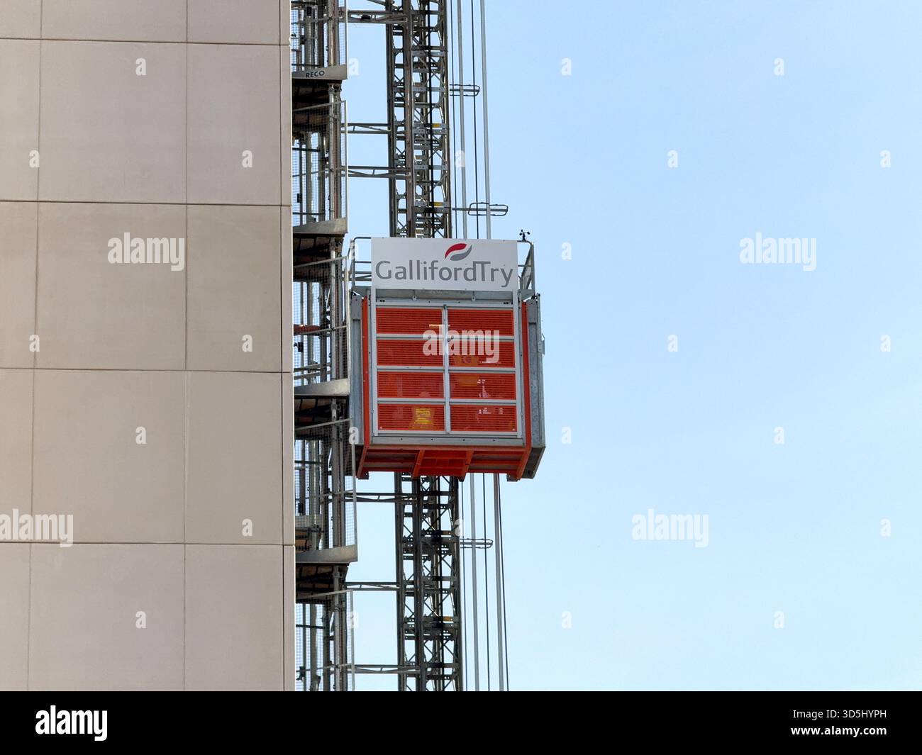 Cardiff, Wales, UK - 15 August 2025: Construction workers working for Galliford Try in an elevator on the outside of a block of apartments in Cardiff - Smartphone Captured Stock Image
