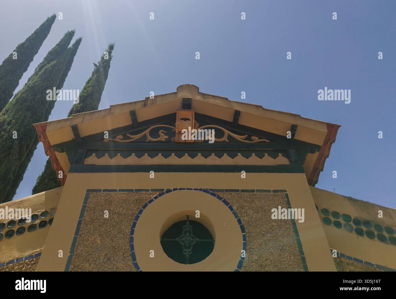 Wooden nest box or bat shelter attached under cornice. Public urban park Stock Photo