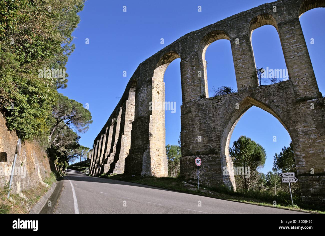Pegoes aqueduct features tall stone arches surrounded by lush greenery ...
