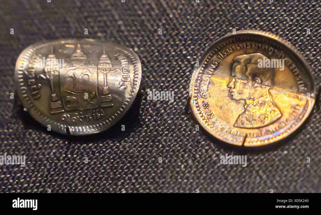 Thai warped coins Stock Photo