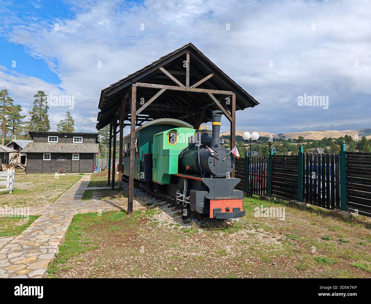 El Paso tourist village with vintage green train under wooden shelter ...