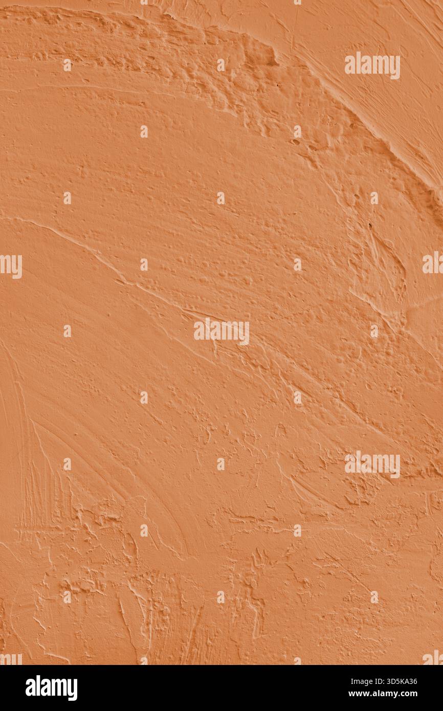 Close up, macro of vibrant orange colored cement wall surface with rough, heavily textured, and abstract plaster strokes. Grunge background, industria Stock Photo