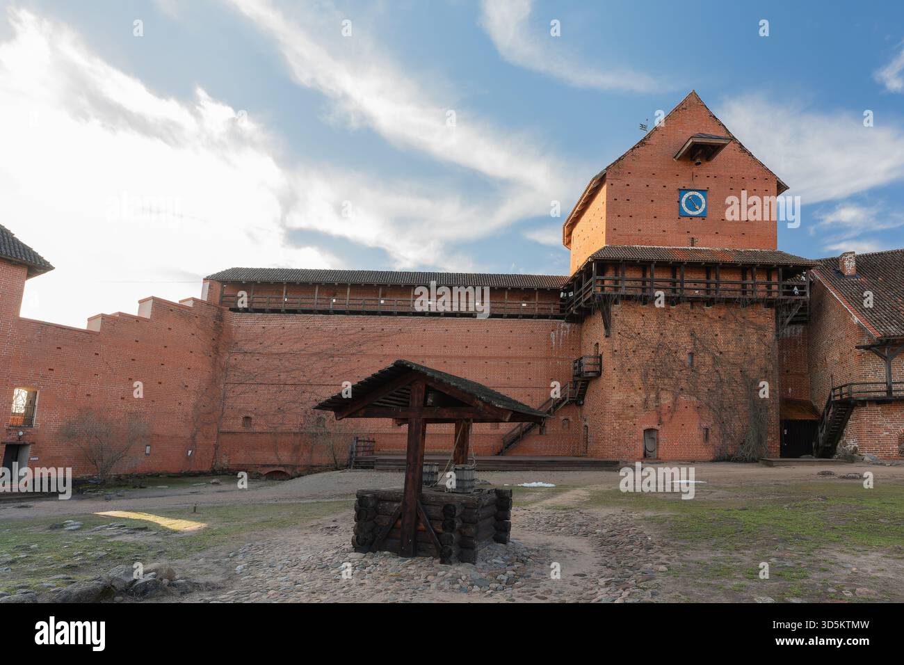 Historic castle walls against a blue sky background, over time it has been used as a fortress, photographed with a wide-angle lens from different angl Stock Photo