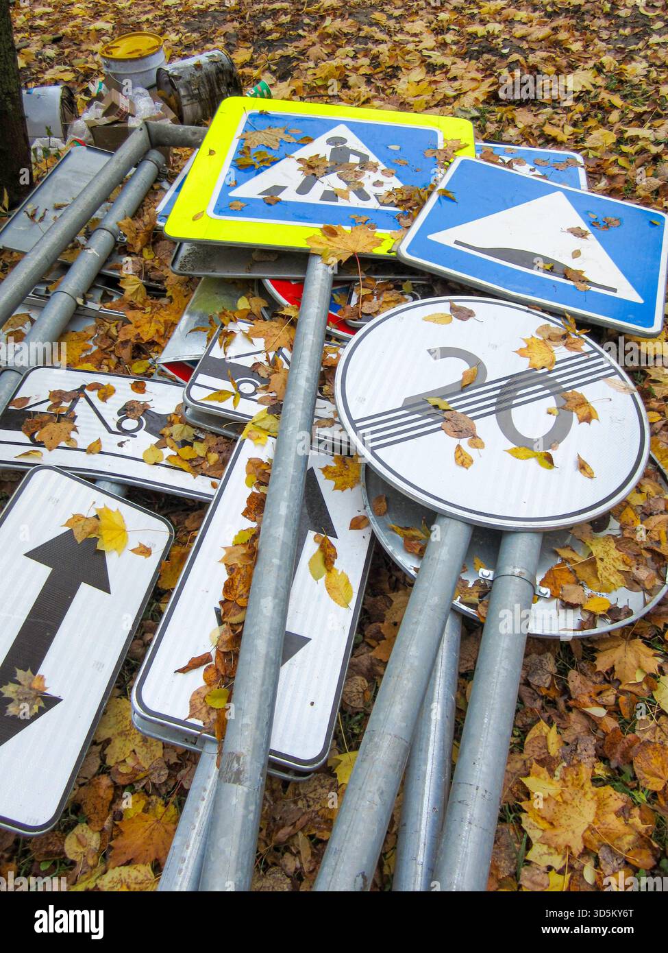 A chaotic heap of traffic signs, poles, and warning boards lies on the ...