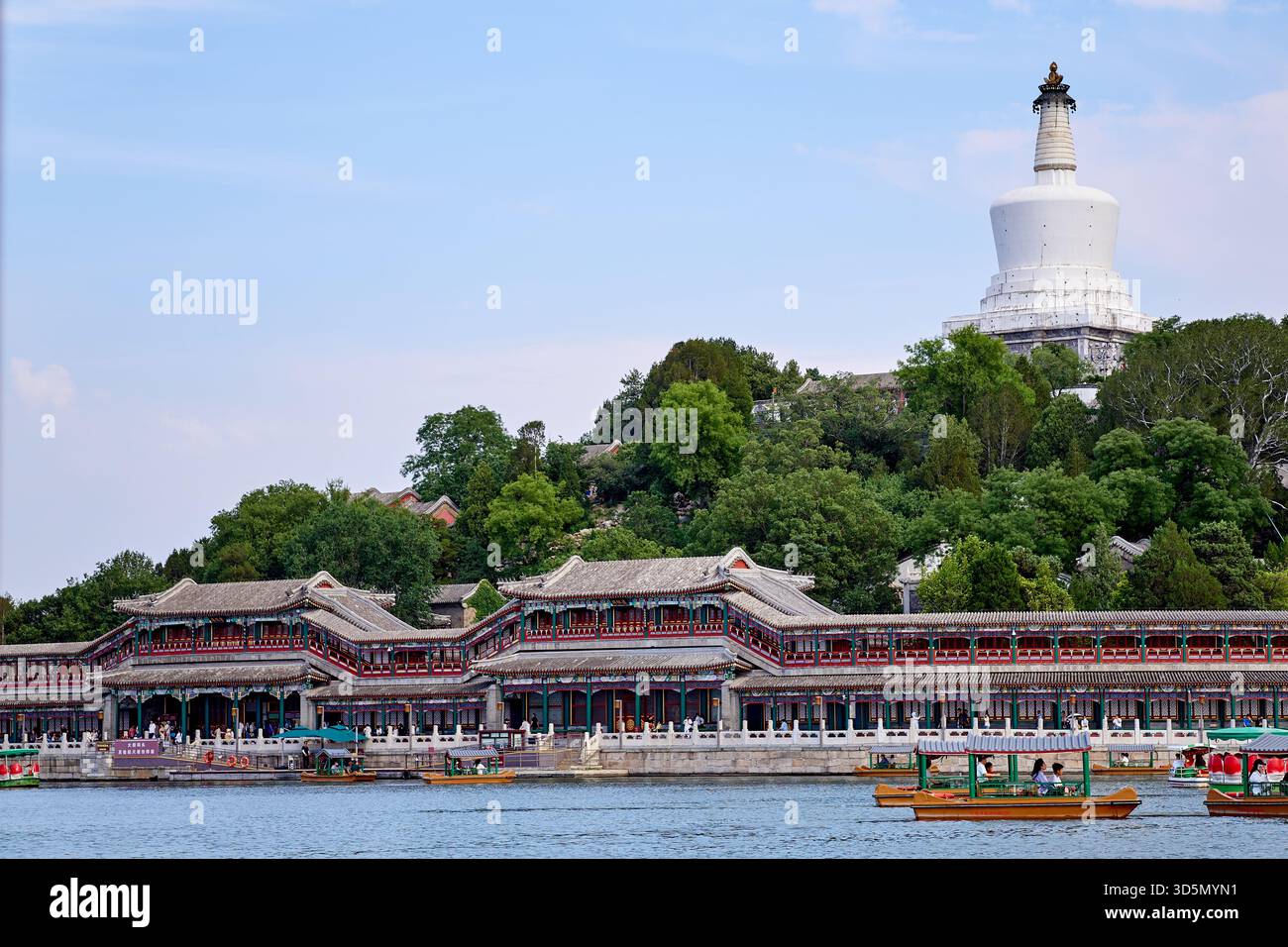 The Tibetan White Dagoba stupa on the Jade Flowery Islet and Yilan Hall with Qiongdao wharf in Beihai Park, Beijing Stock Photo