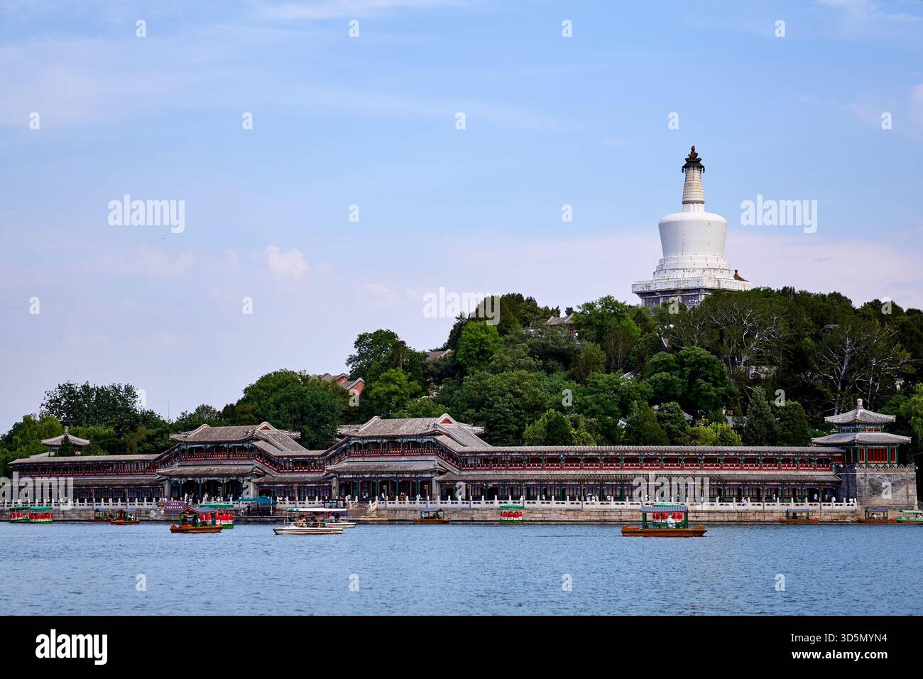 The Tibetan White Dagoba stupa on the Jade Flowery Islet and Yilan Hall with Qiongdao wharf in Beihai Park, Beijing Stock Photo