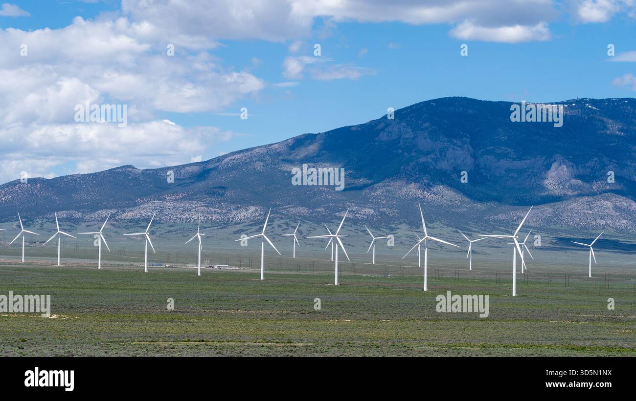 Windmills on the field with mountains in the background. Nevada, USA. Stock Photo
