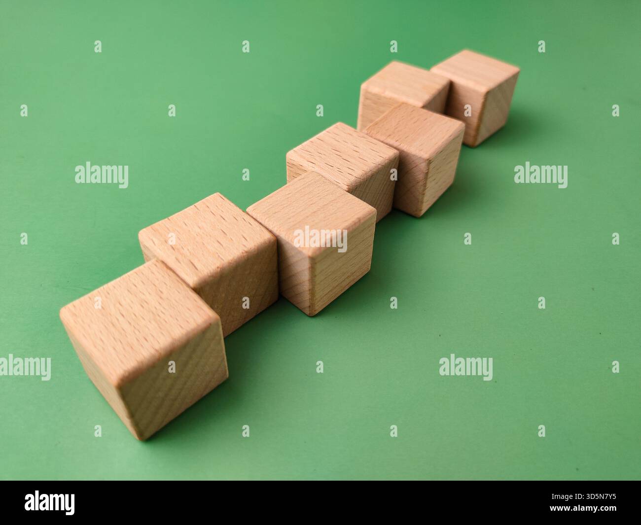 The image displays a set of eight small, smooth, unfinished wooden ...