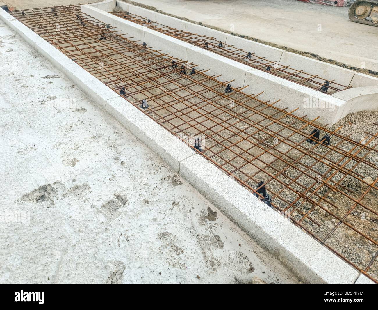 Rebar reinforcement in formwork for concrete steps and sidewalk before pour at jobsite Stock Photo