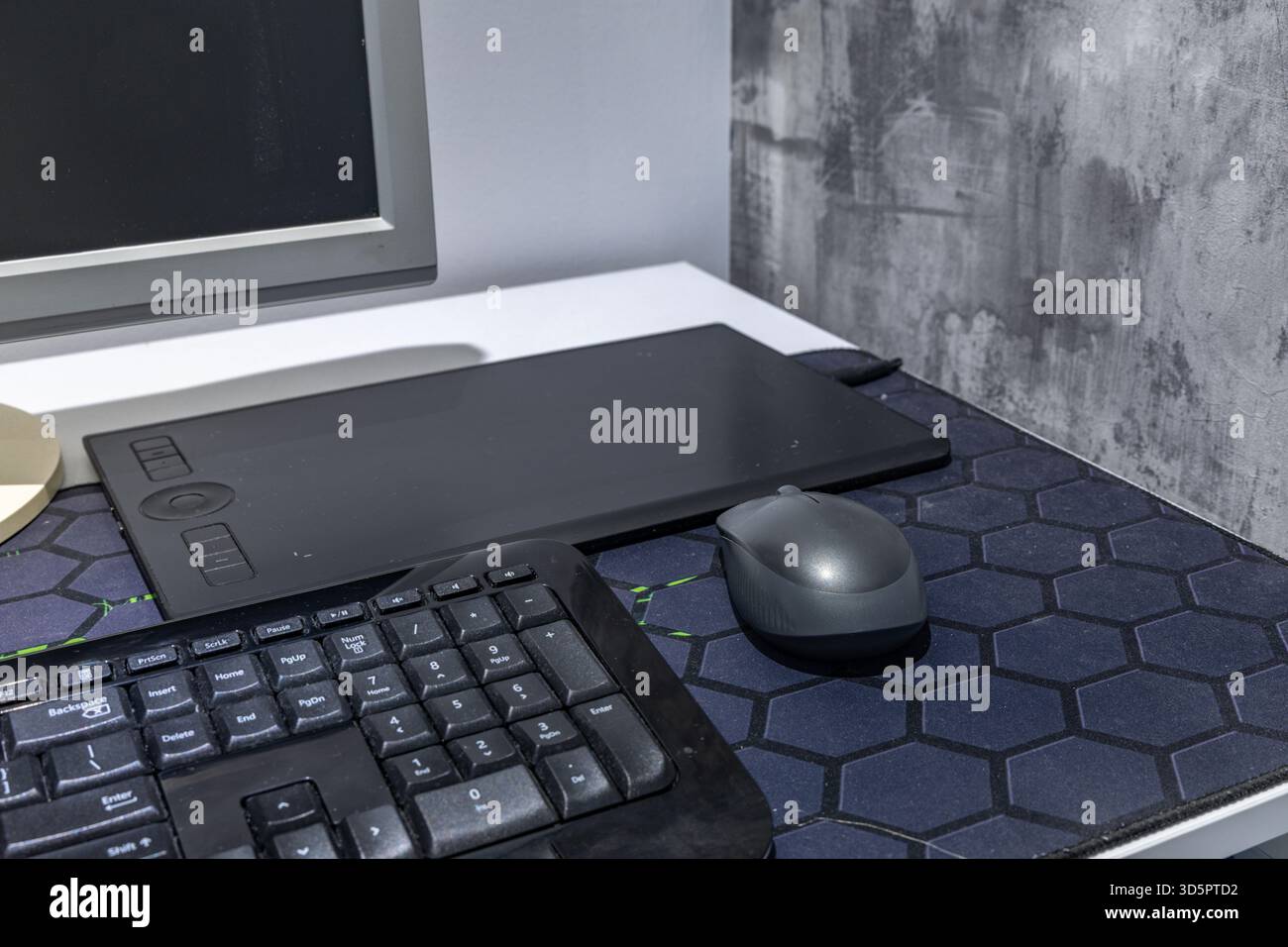A computer graphics desk, a wireless mouse and a pen for drawing on the ...