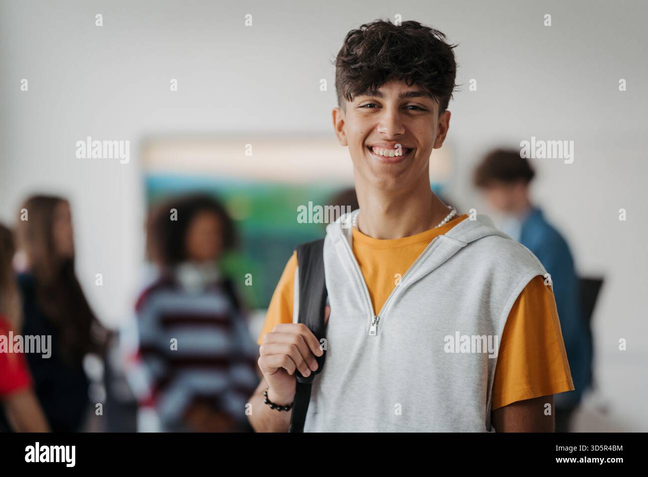 Confident teen student standing in modern classroom Stock Photo - Alamy
