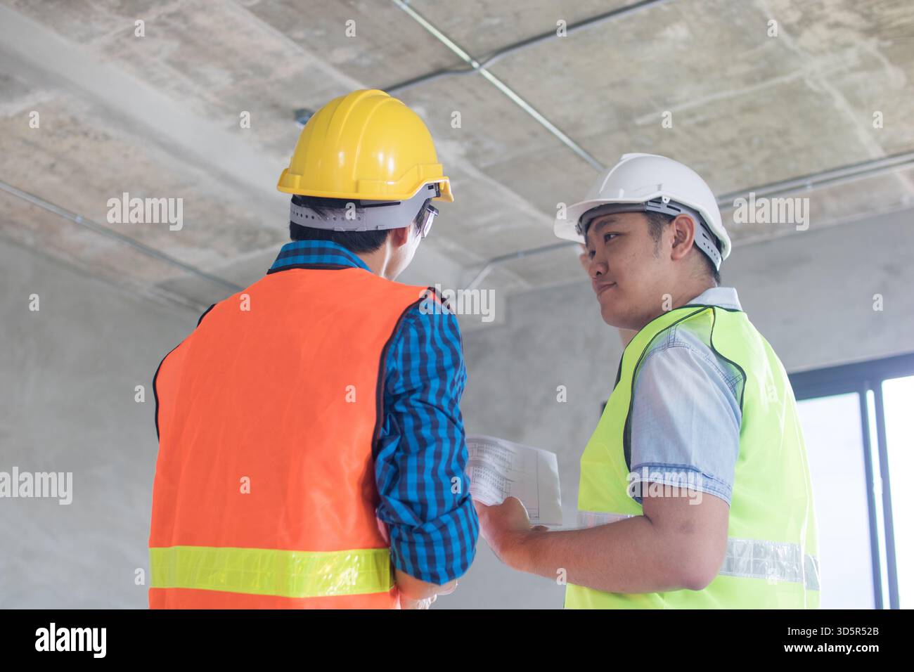 engineer with worker check and work in building Stock Photo