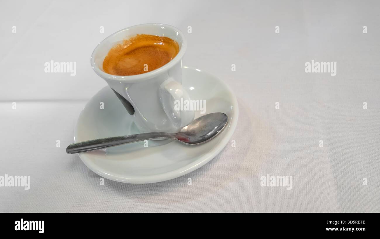 Coffee Cup with Saucer and Spoon on a White Background Stock Photo