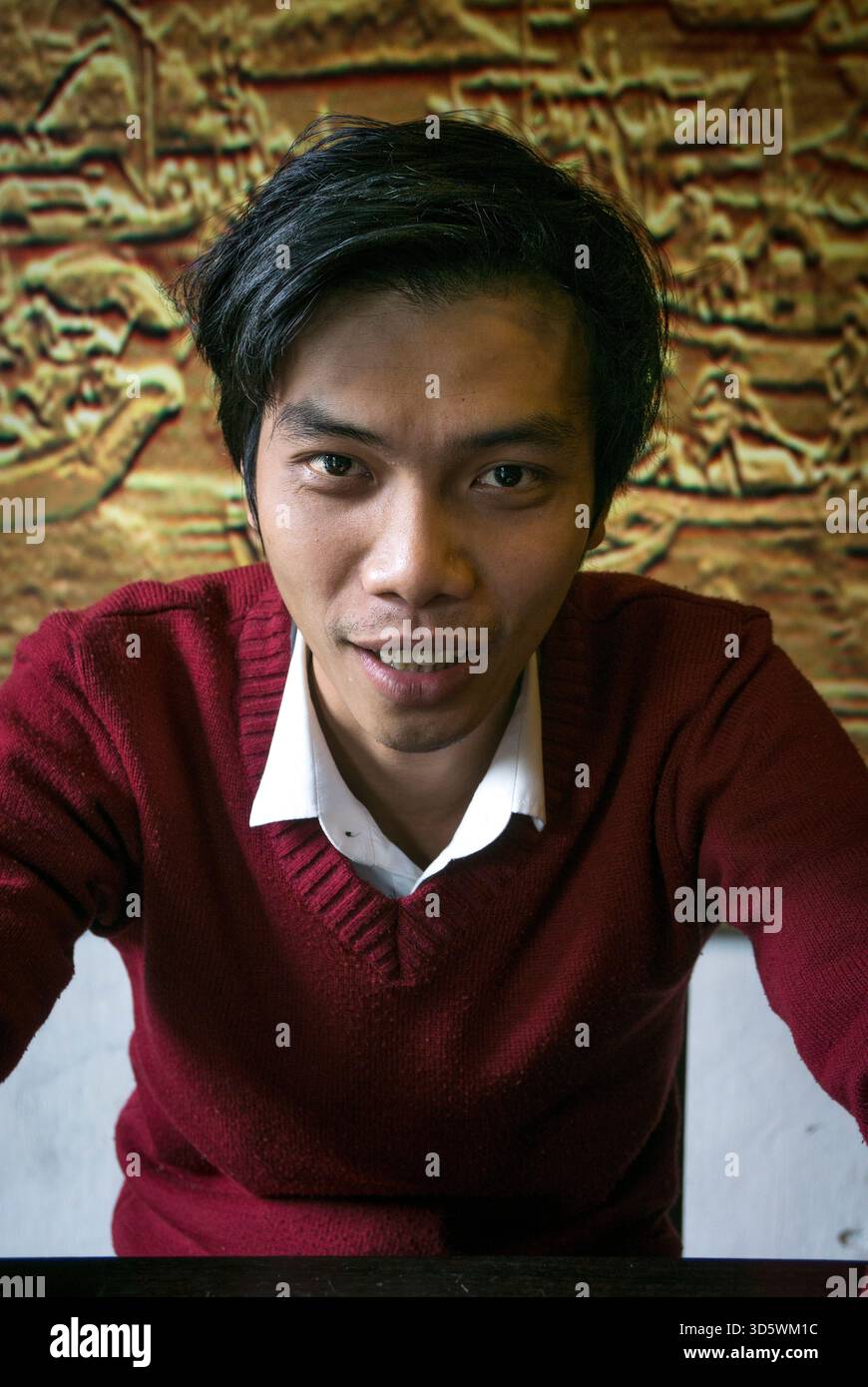 Young man looking into camera in Hoi An, Vietnam Stock Photo