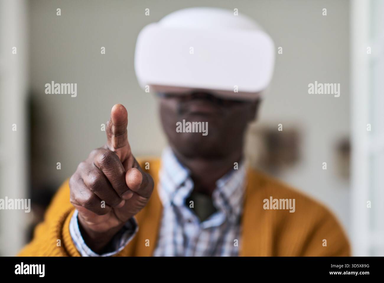 Mature Black Man Using Virtual Reality Headset and Interacting Digitally Stock Photo