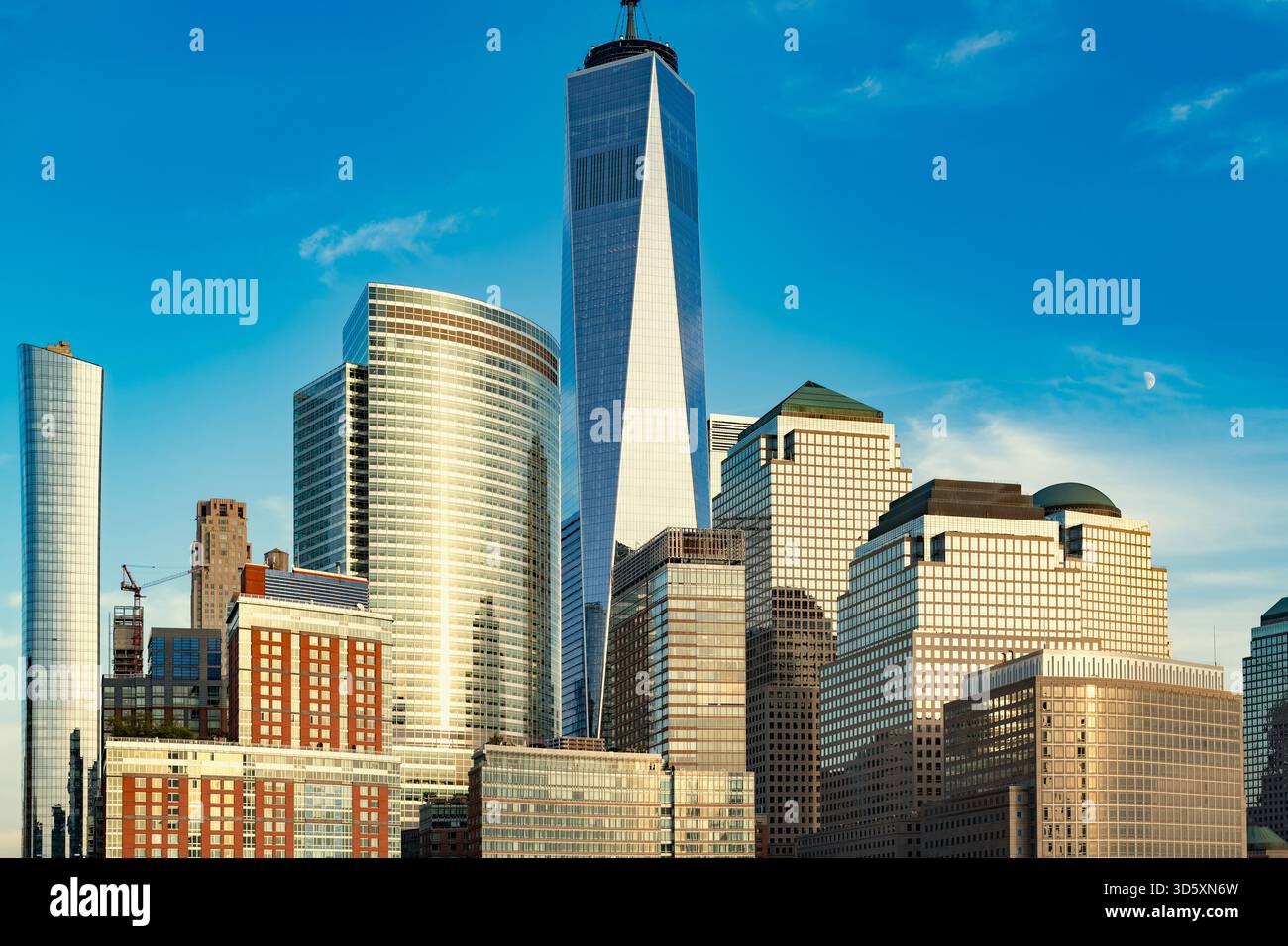 The urban density of lower Manhattan at dusk, featuring iconic skyscrapers and residential towers bathed in the colors of the sunset. Stock Photo
