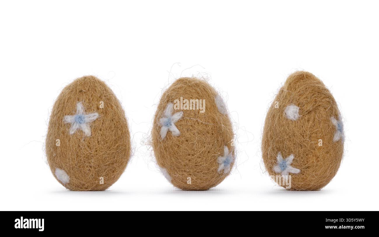 Three easter eggs decorated with small white and light blue flowers. Standing, isolated on a white background, Netherlands Stock Photo