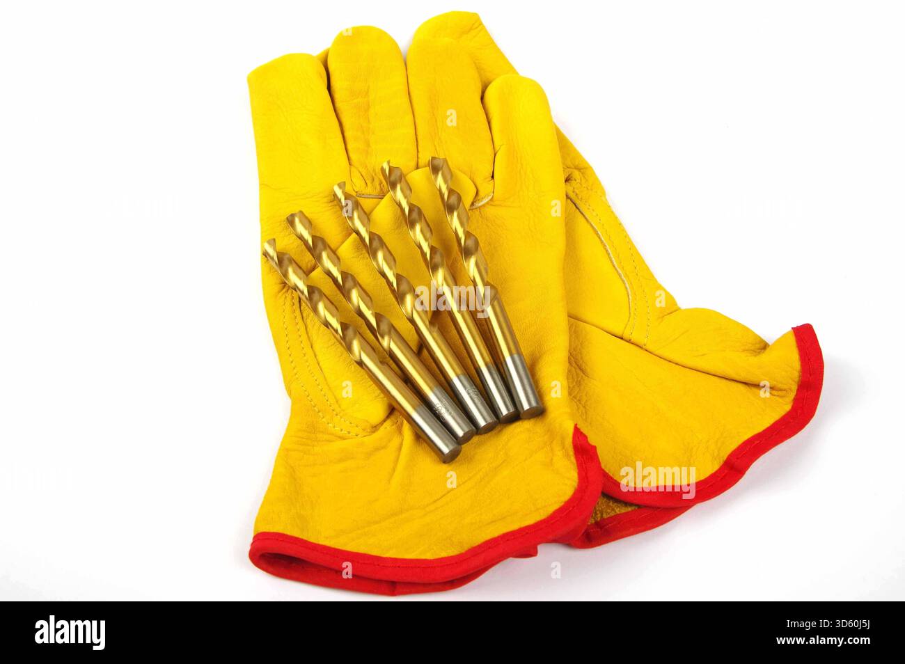 metal drill bits and leather work gloves on a white background Stock Photo