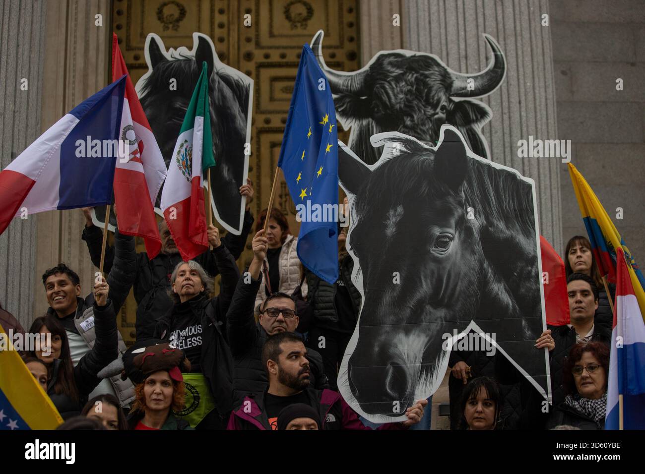 Activists carry cardboard bull heads and a horse during a demonstration ...