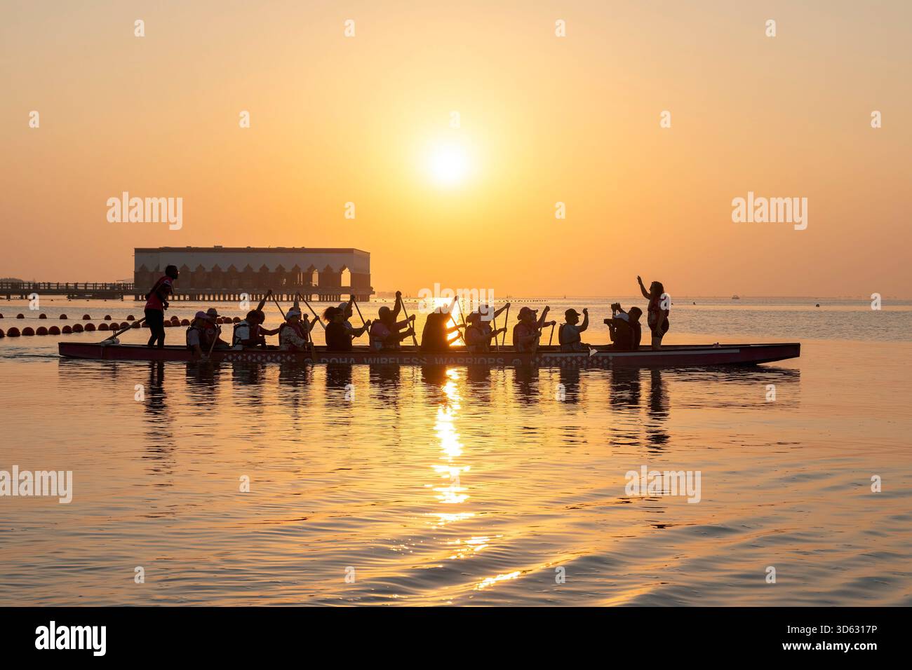 Doha, Qatar - October 24, 2025: Silhouette people rowing dragon boat at ...