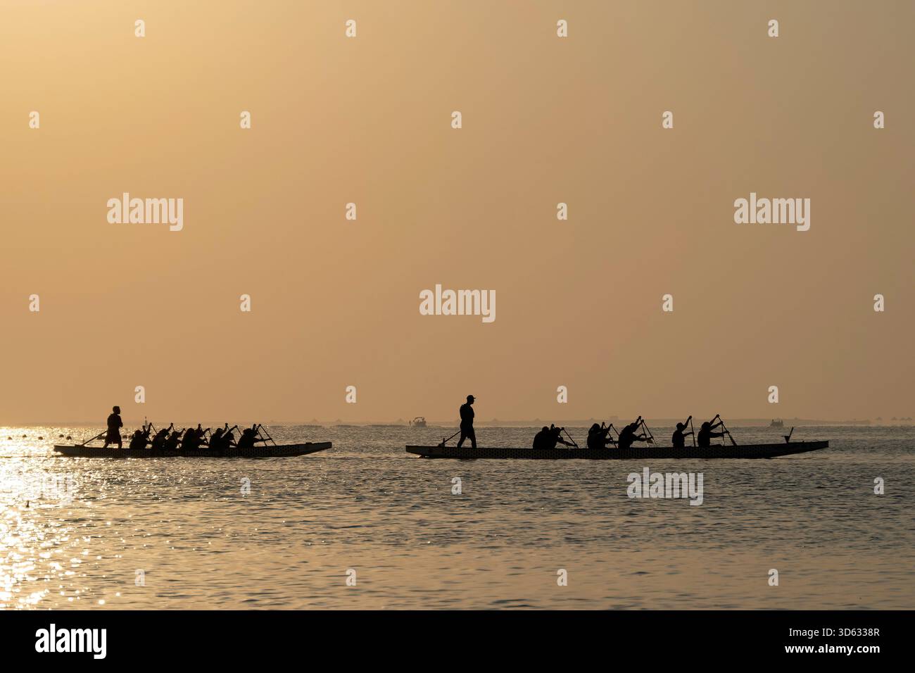 Doha, Qatar - October 24, 2025: Silhouette people rowing dragon boat at ...