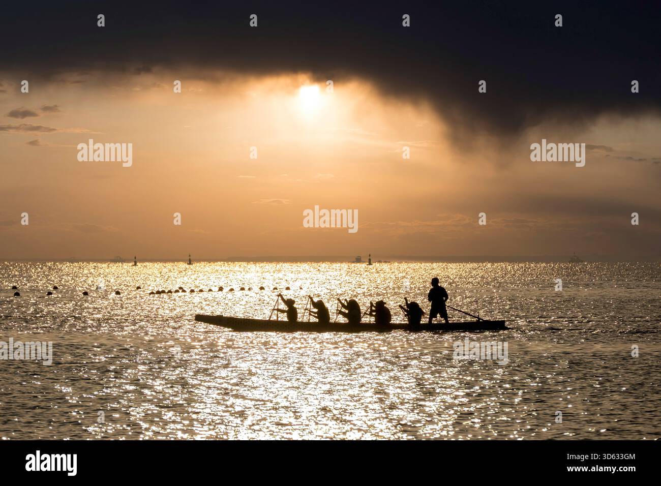 Doha, Qatar - October 24, 2025: Silhouette people rowing dragon boat at ...