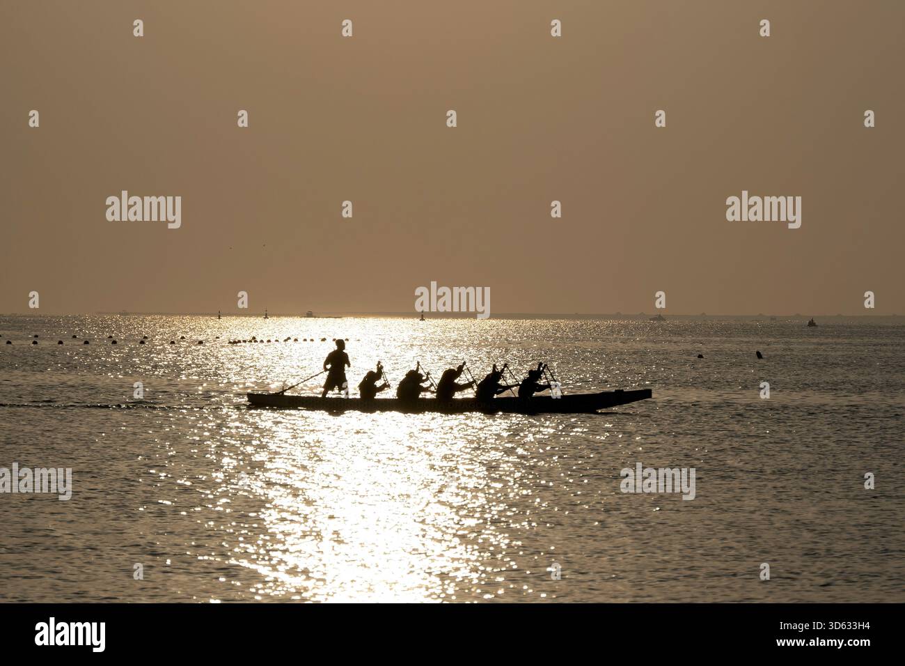 Doha, Qatar - October 24, 2025: Silhouette people rowing dragon boat at ...