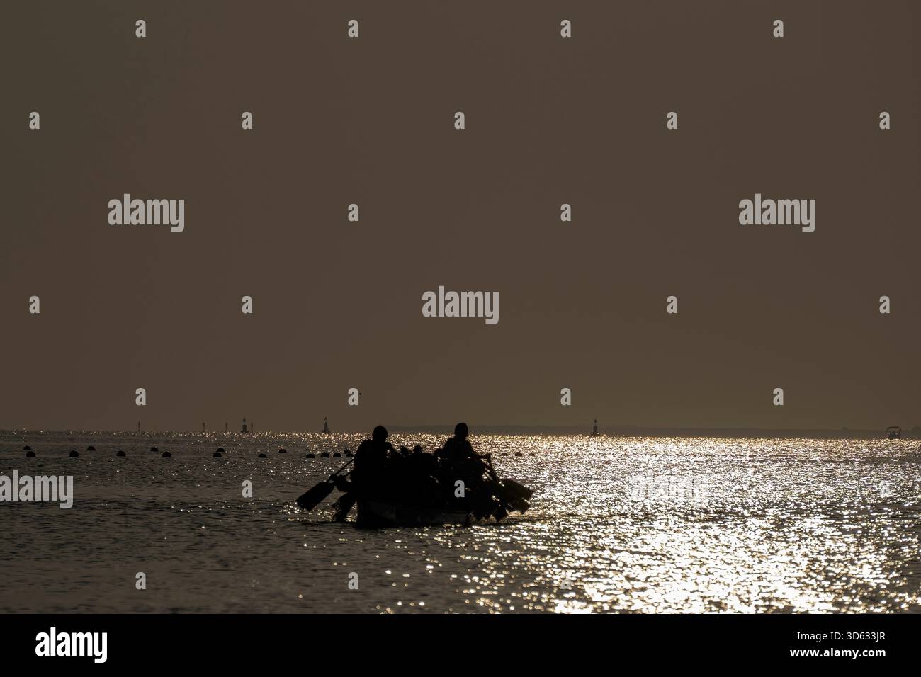 Doha, Qatar - October 24, 2025: Silhouette people rowing dragon boat at ...