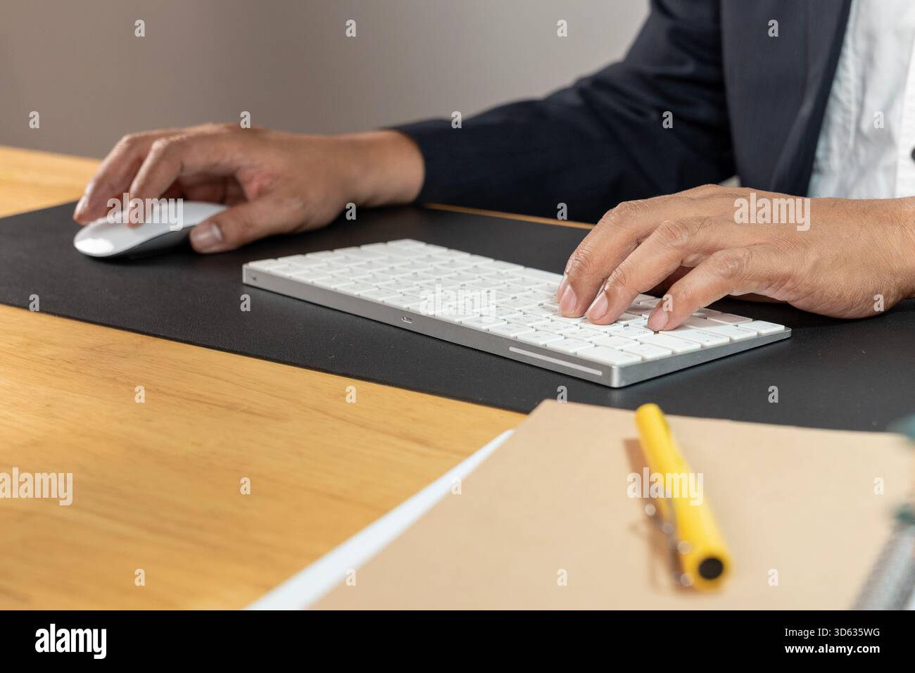 Young office worker sits at the computer working with his mind in mind Stock Photo