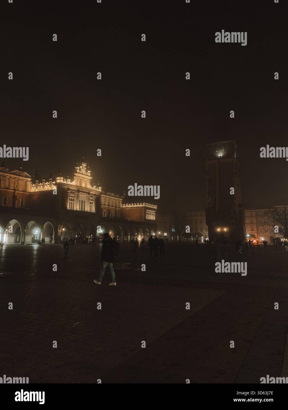 Misty Night Scene of Kraków Old Town, Poland with Foggy Streets and Historic Architecture - Smartphone Captured Stock Image