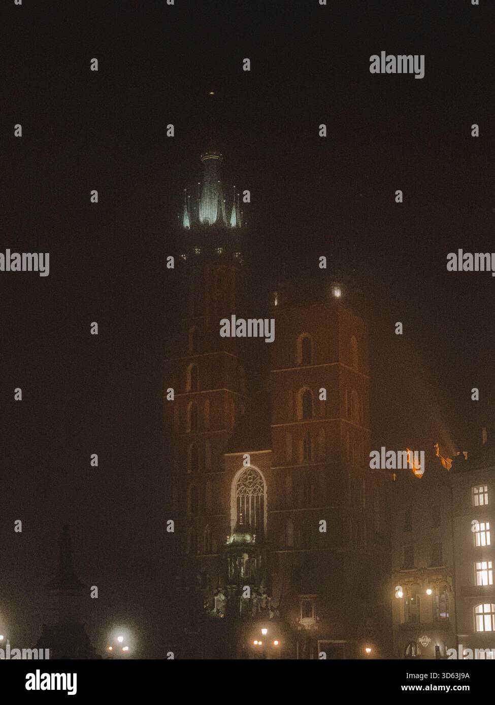 Misty Night Scene of Kraków Old Town, Poland with Foggy Streets and Historic Architecture - Smartphone Captured Stock Image