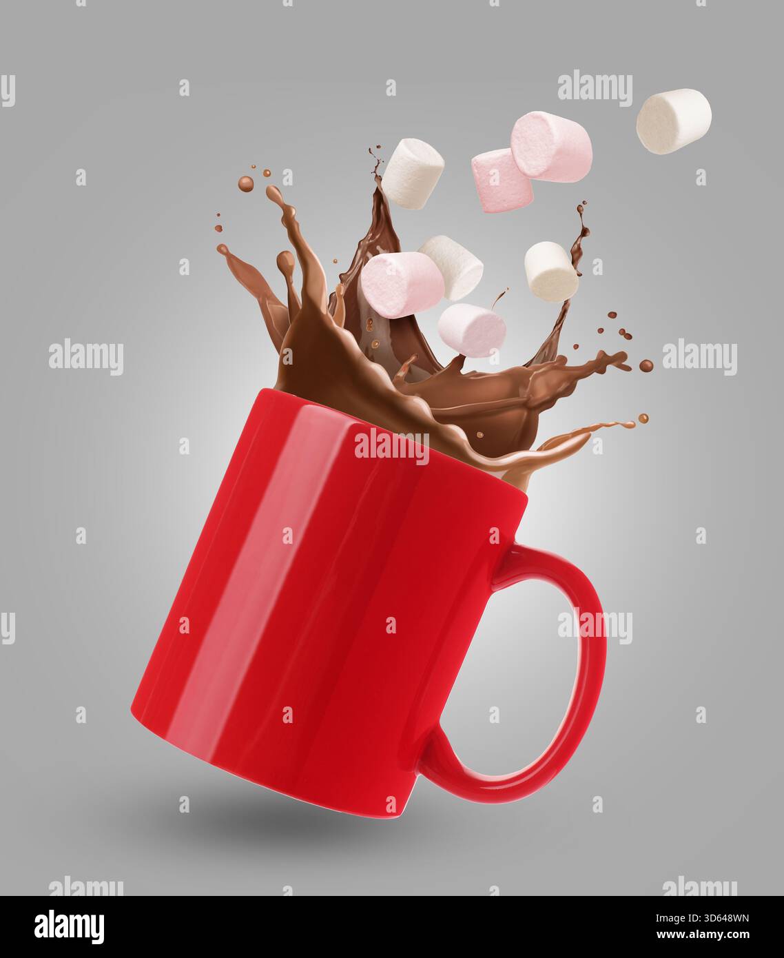 Fresh marshmallows falling into cup with hot cocoa on grey background Stock Photo