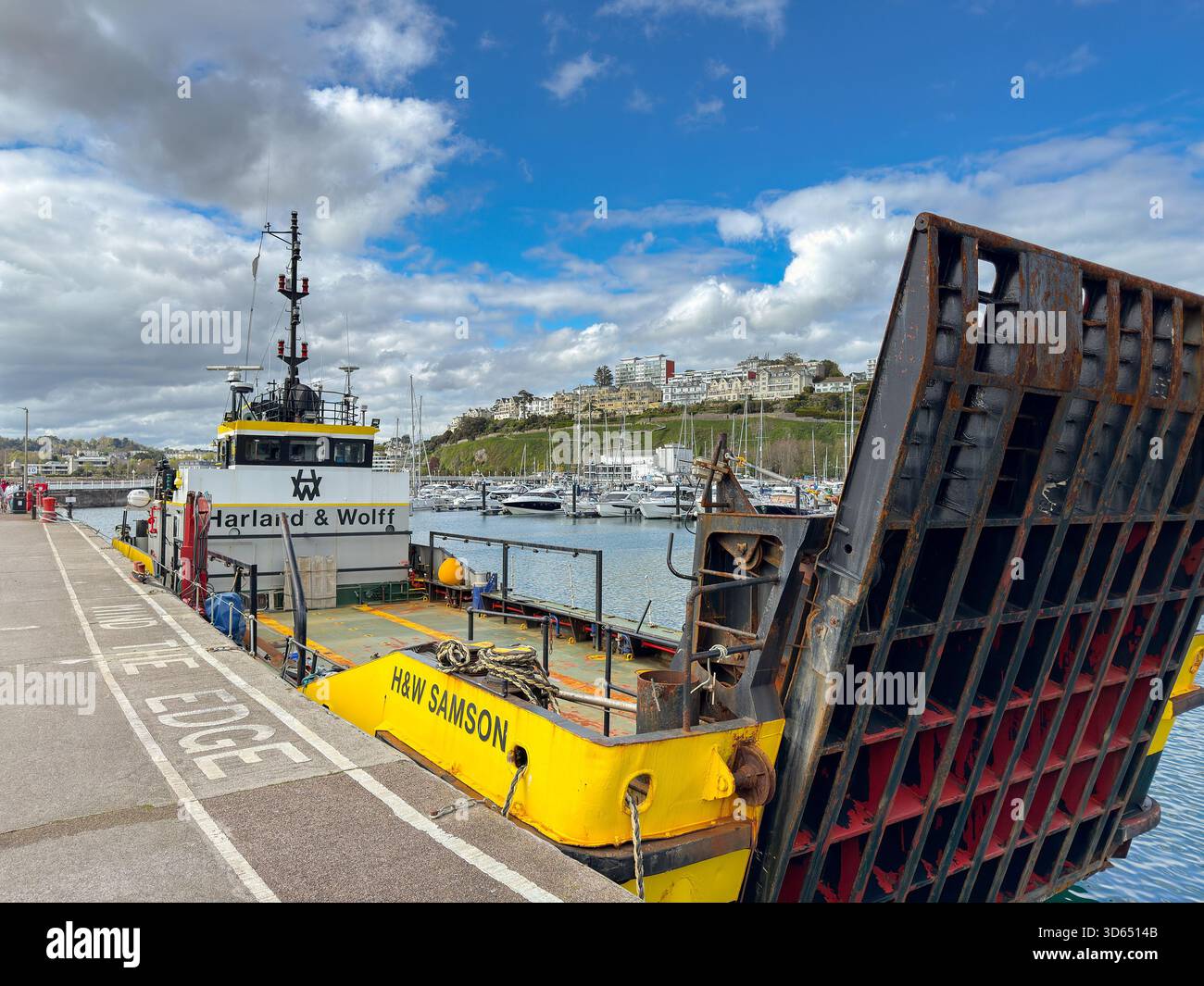 Torquay, Devon, England, UK - 23 April 2025: Industrial boat H&W Samson with a loading ramp owned by Harland and Wolff in the harbour in Torquay - Smartphone Captured Stock Image
