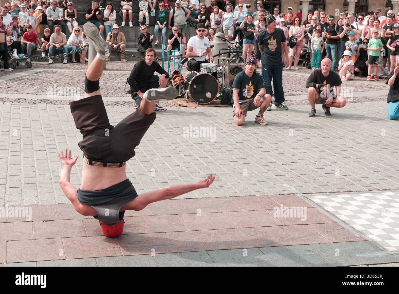 A man hip hop dancer or bboy freezes in one pose on a white