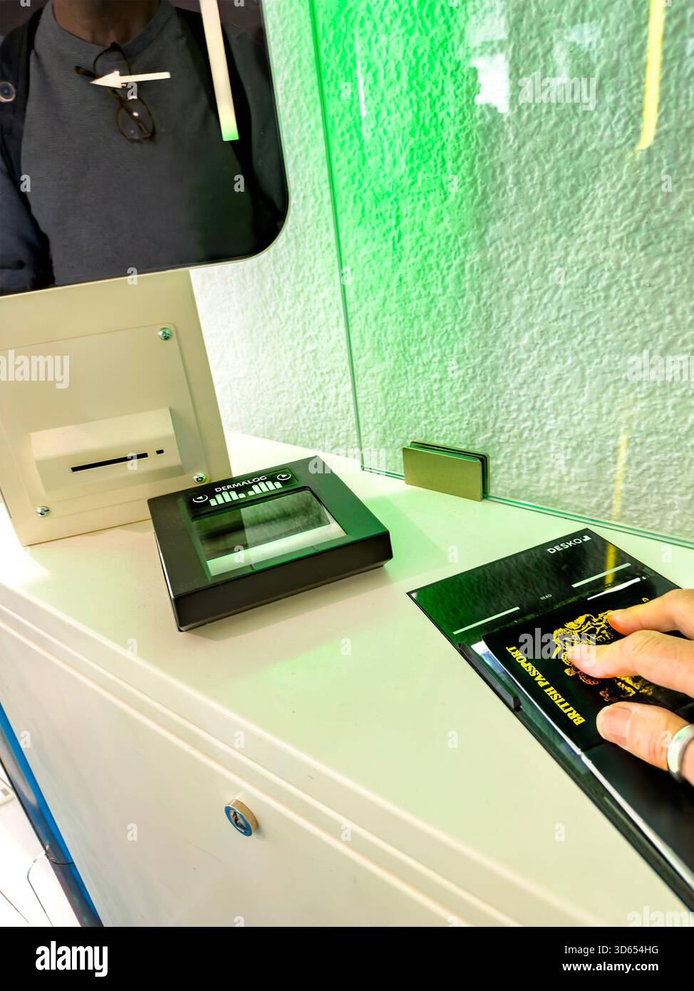 Person scanning fingerprints and passport at an automated border control checkpoint with biometric verification technology EES - Smartphone Captured Stock Image