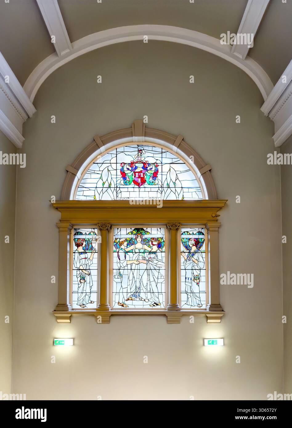 Elegant stained glass window with decorative coat of arms and classical moulding in an interior archway Laing art gallery, newcastle upon tyne - Smartphone Captured Stock Image