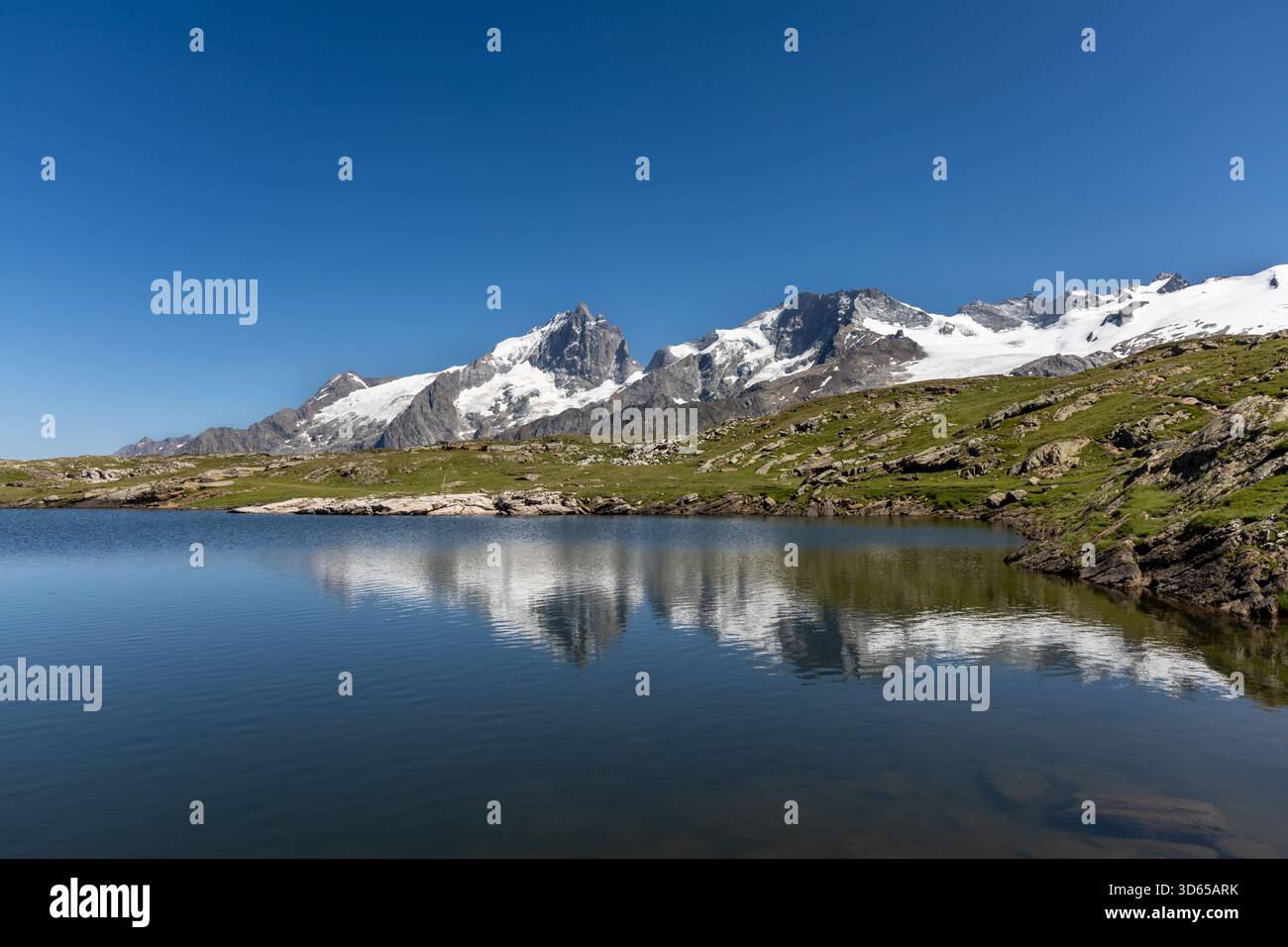 Lac Noir With A Scenic View Of La Meije Peak On The Emparis Plateau In lac-noir-with-a-scenic-view-of-la-meije-peak-on-the-emparis-plateau-in