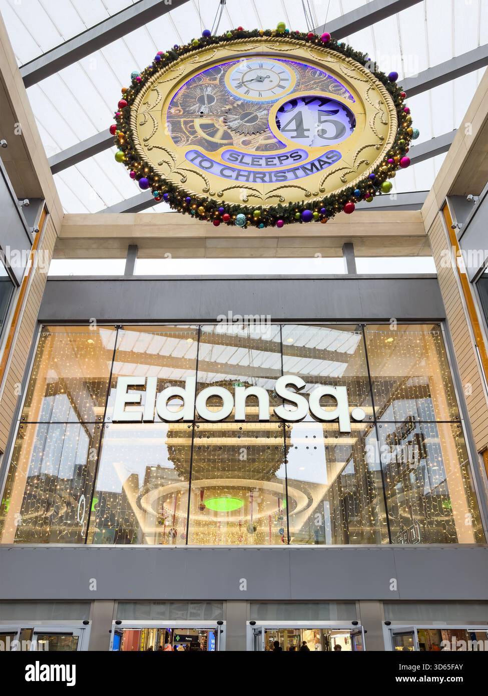 Large decorative Christmas countdown clock hanging above entrance to Eldon Square shopping centre newcastle festive lights visible inside - Smartphone Captured Stock Image