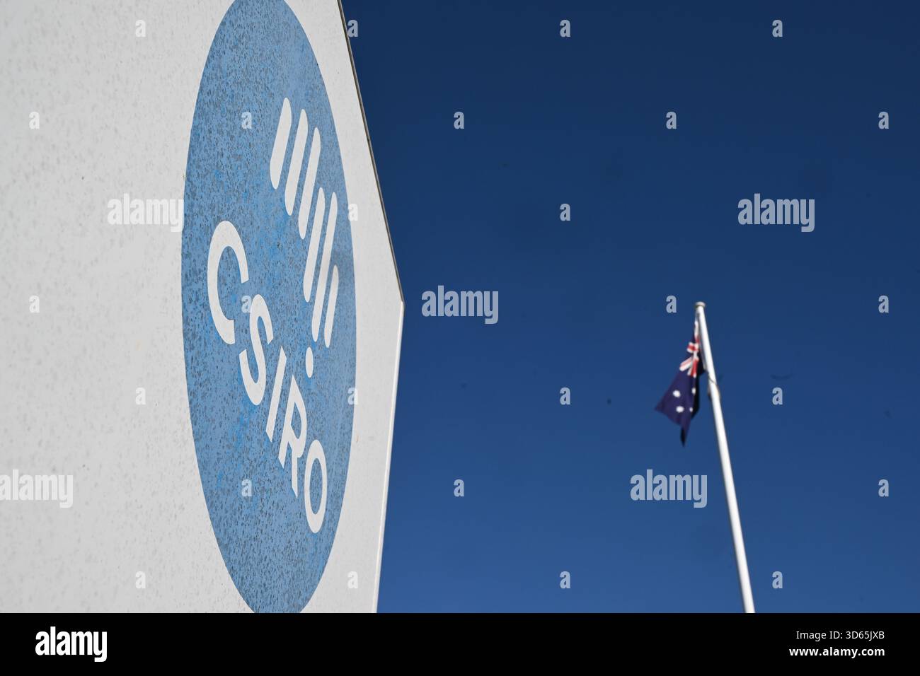 The Australian flag flies next to a sign of the Commonwealth Scientific ...