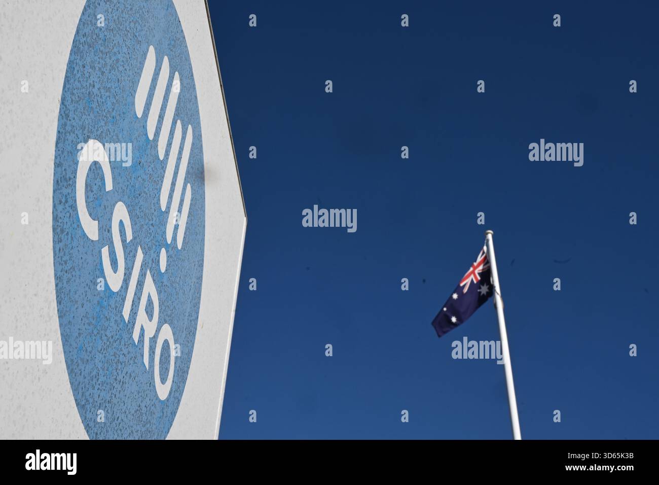 The Australian flag flies next to a sign of the Commonwealth Scientific ...
