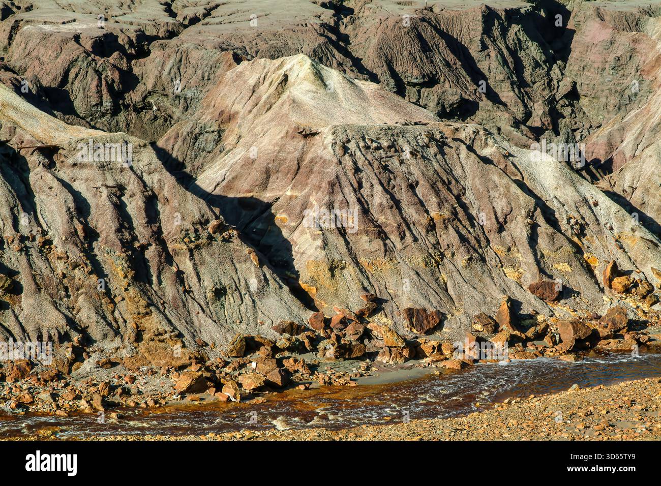 The highly acidic river flows past mineral-stained banks near the Rio ...