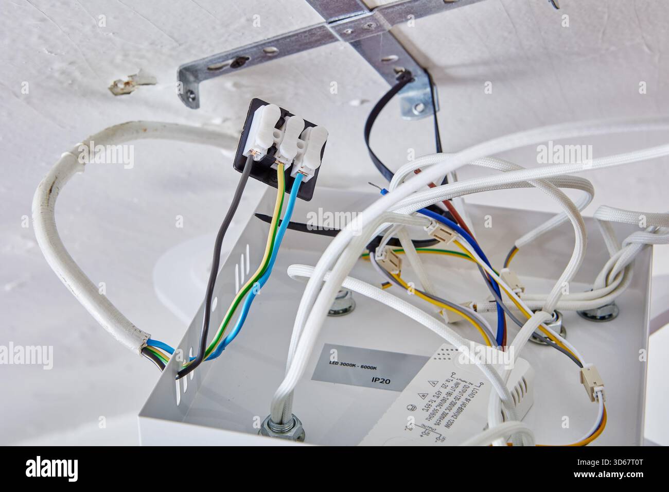 Led Ceiling Wire Connecting wires to terminal block during LED chandelier mounting on ...