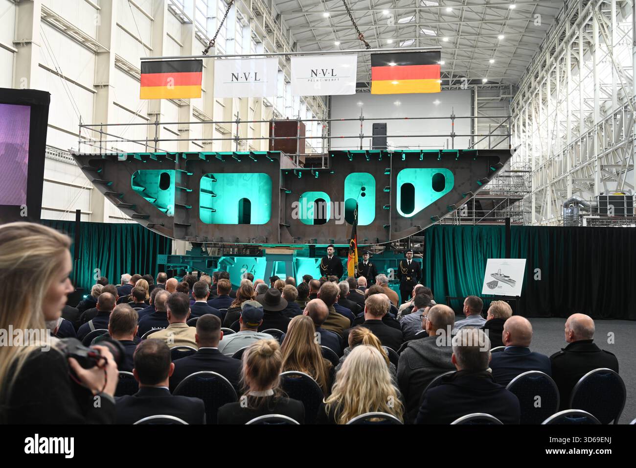 Wolgast, Germany. 19th Nov, 2025. Keel laying of the second fleet service boat in the shipyard hall of the Peene shipyard. The contract for the construction was awarded to the Bremen-based Naval Vessels Lürssen Group (NVL). Work on the ships is to be carried out at several shipyards in northern Germany. Credit: Stefan Sauer/dpa/Alamy Live News Stock Photo