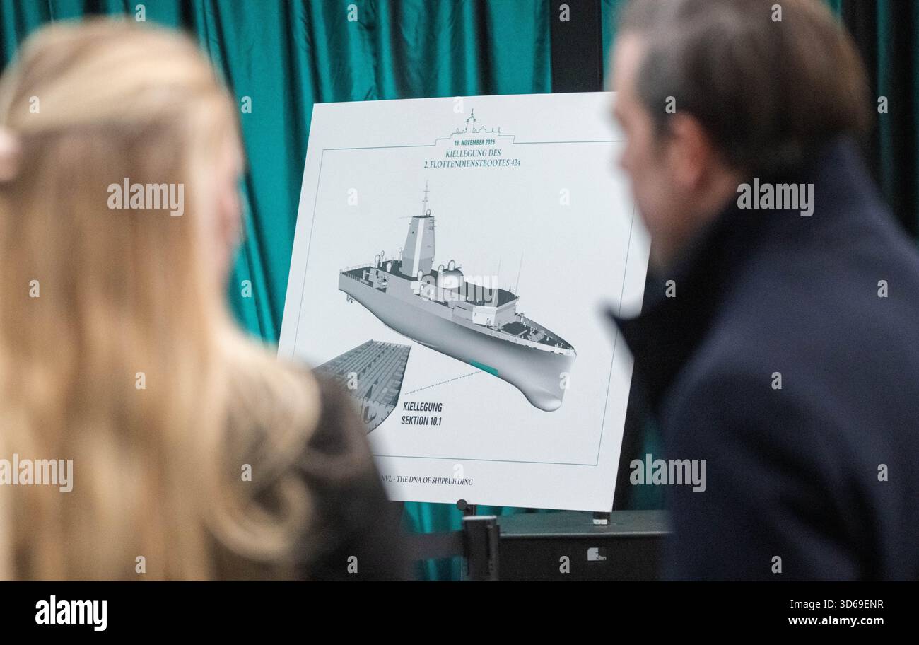 Wolgast, Germany. 19th Nov, 2025. An illustration of the keel laying of the second fleet service boat in the shipyard hall of the Peene shipyard. The Bremen-based Naval Vessels Lürssen Group (NVL) was awarded the contract for the construction. Work on the ships is to be carried out at several shipyards in northern Germany. Credit: Stefan Sauer/dpa - ATTENTION: Only for editorial use in connection with current reporting and only with full reference to the above credit/dpa/Alamy Live News Stock Photo
