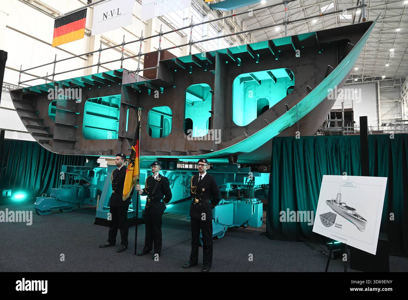 Wolgast, Germany. 19th Nov, 2025. Keel laying of the second fleet service boat in the shipyard hall of the Peene shipyard. The contract for the construction was awarded to the Bremen-based Naval Vessels Lürssen Group (NVL). Work on the ships is to be carried out at several shipyards in northern Germany. Credit: Stefan Sauer/dpa/Alamy Live News Stock Photo