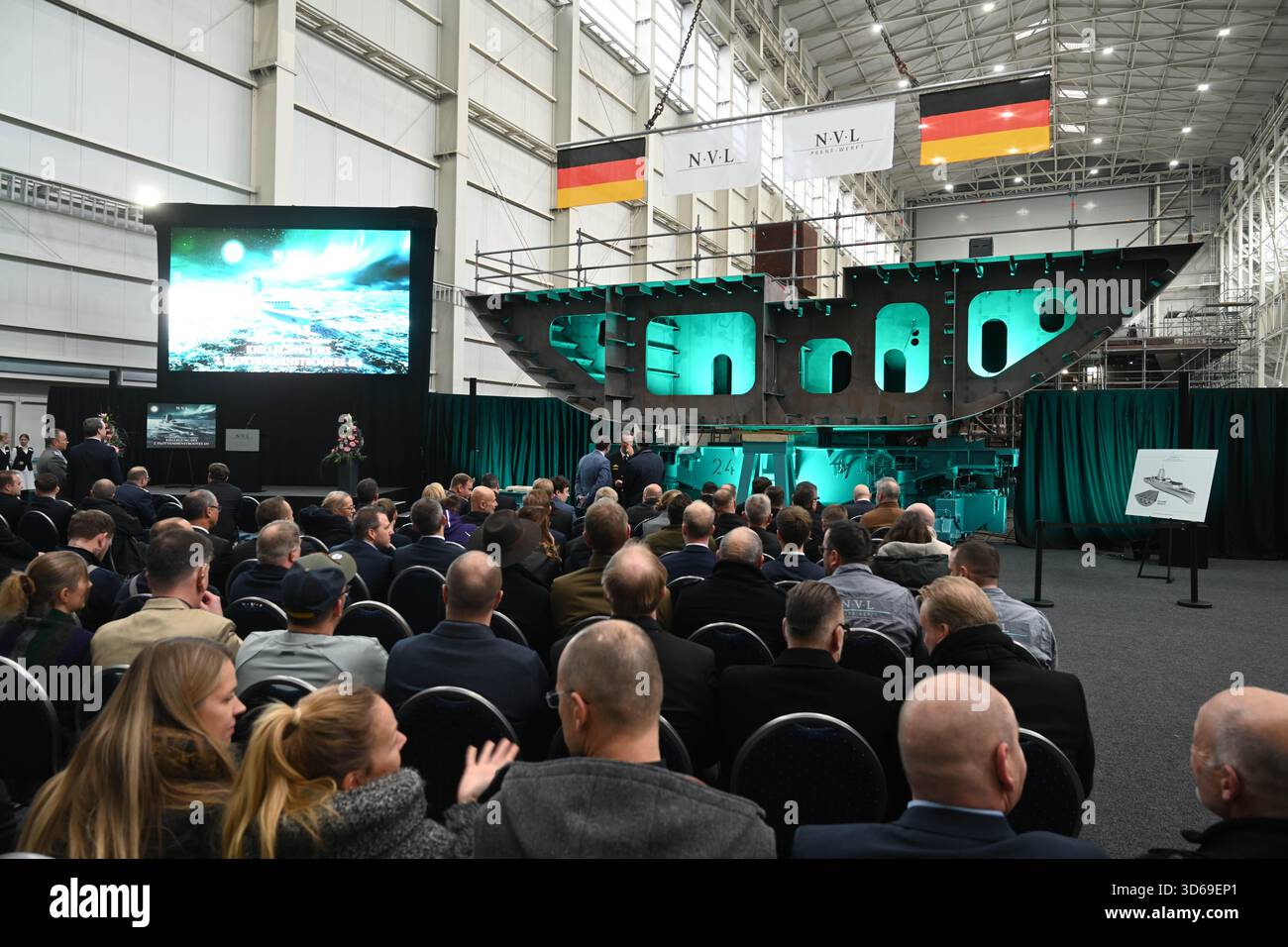 Wolgast, Germany. 19th Nov, 2025. Keel laying of the second fleet service boat in the shipyard hall of the Peene shipyard. The contract for the construction was awarded to the Bremen-based Naval Vessels Lürssen Group (NVL). Work on the ships is to be carried out at several shipyards in northern Germany. Credit: Stefan Sauer/dpa/Alamy Live News Stock Photo
